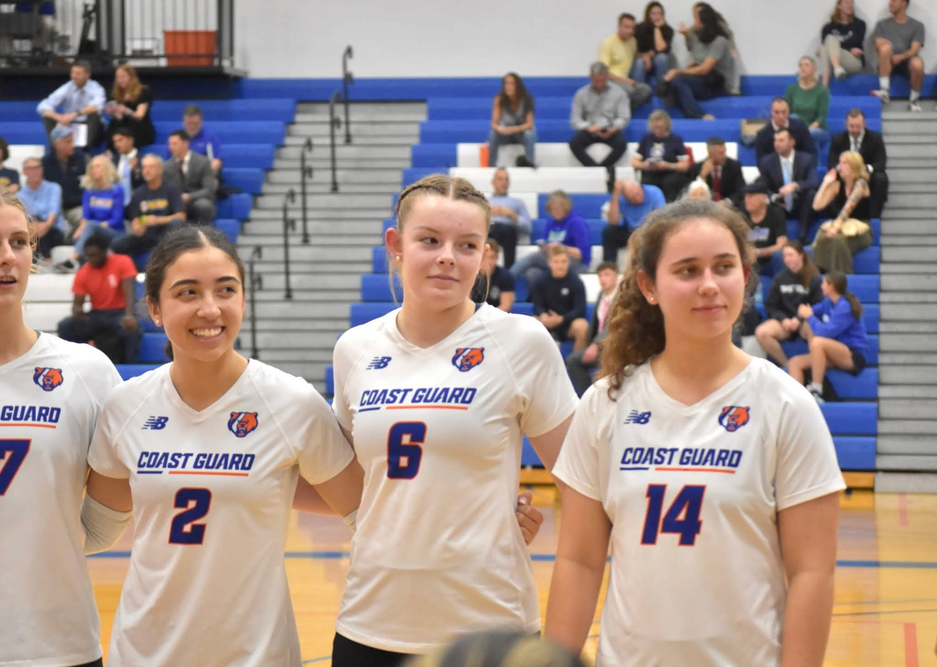 Bella Samaniego standing with Coast Guard Academy women's volleyball teammates