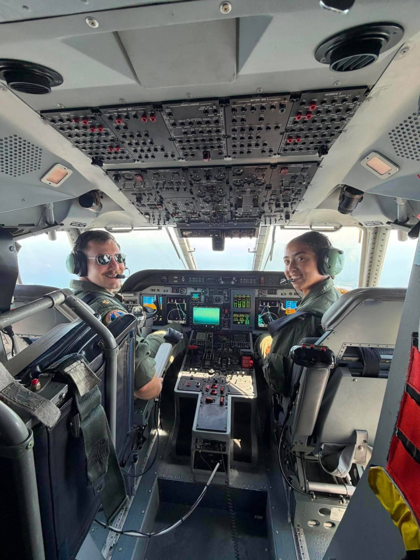 Bella Samaniego in the cockpit of a Coast Guard aircraft during an orientation flight